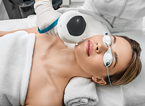 young woman receiving laser skincare treatment