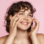 natural girl smiling, rubbing her face