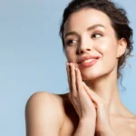 A woman with radiant skin and clean hands, emphasizing the ABCDE rule for melanoma awareness and skin care