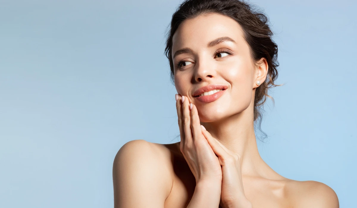 A woman with radiant skin and clean hands, emphasizing the ABCDE rule for melanoma awareness and skin care