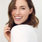 Smooth Results with Dysport A woman laughing and looking back, showcasing the natural-looking and smooth aesthetic results achieved with Dysport.