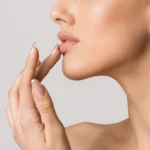 Beautiful girl touching her lips
