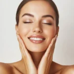 Happy model touching face after facial laser aesthetics